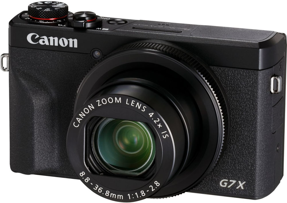 Black Canon camera with zoom lens. The camera has buttons and a dial on top. G7X mark III is visible.