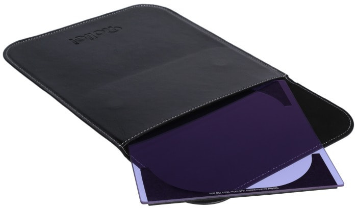 Black leather case with a filter inside. The filter is purple and rectangular.