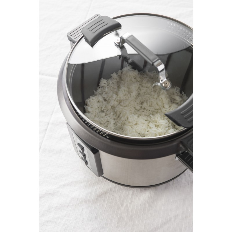 Rice cooker with cooked rice inside. The lid is open, and the interior is visible.