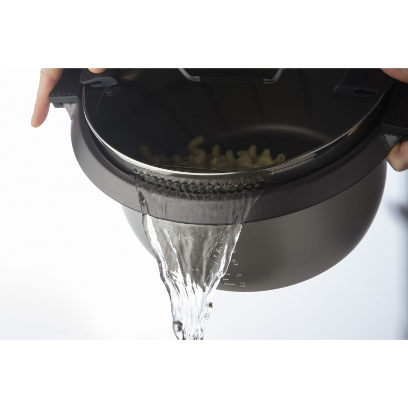 Water being poured from a black pot with pasta inside.