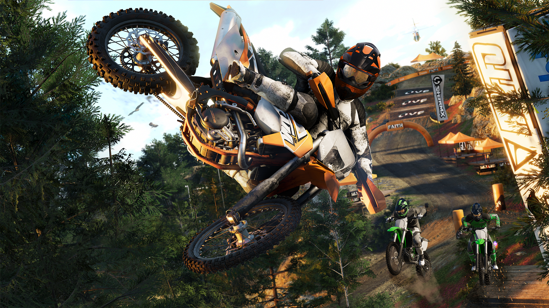 Pilotes de motocross en action, sautant sur une piste de terre avec des arbres et un hélicoptère.