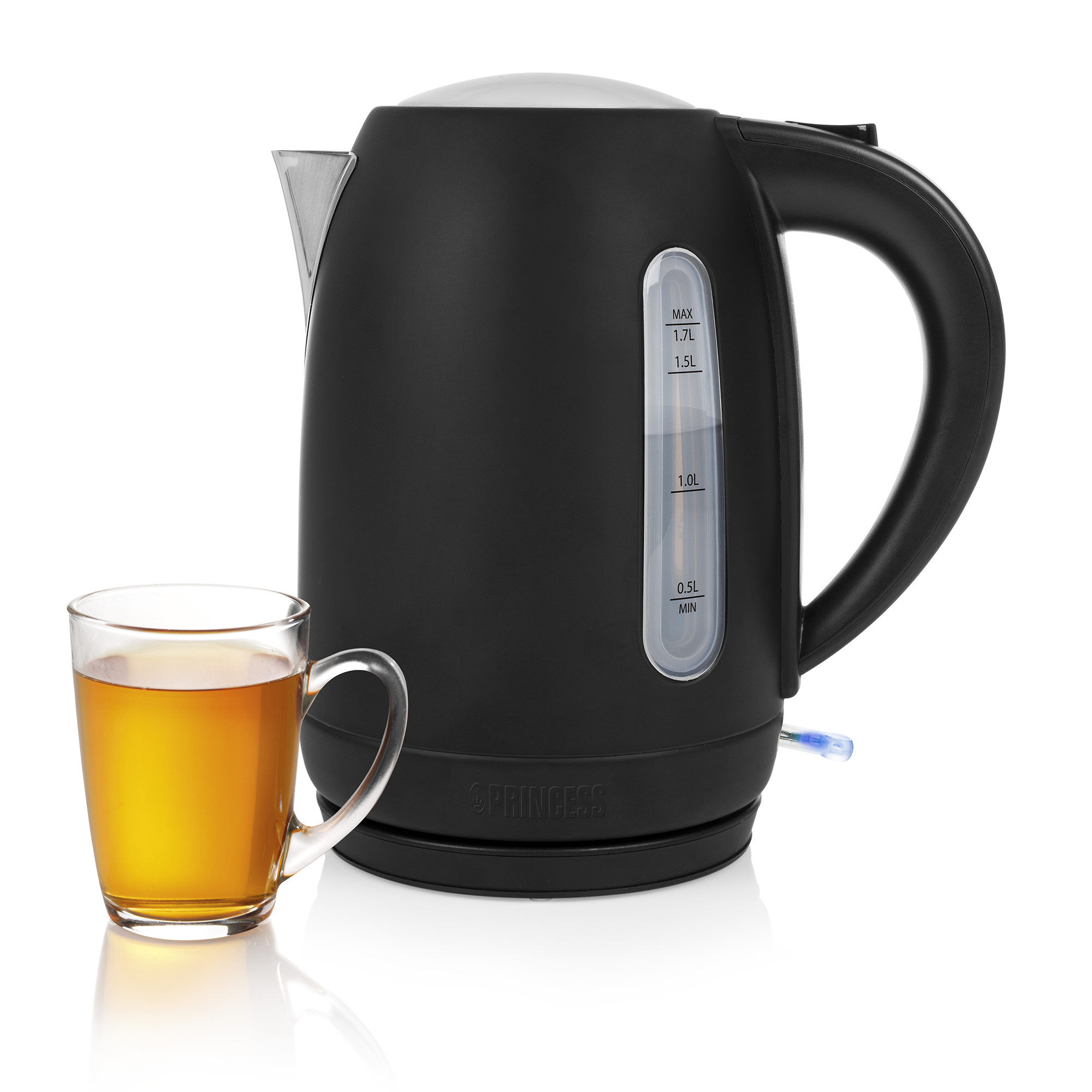 Black electric kettle with a glass of tea beside it. White background.