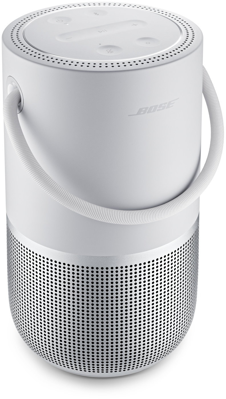 Ein weißer Bose-Lautsprecher mit Griff, zylindrischer Form und perforierter Metallbasis.