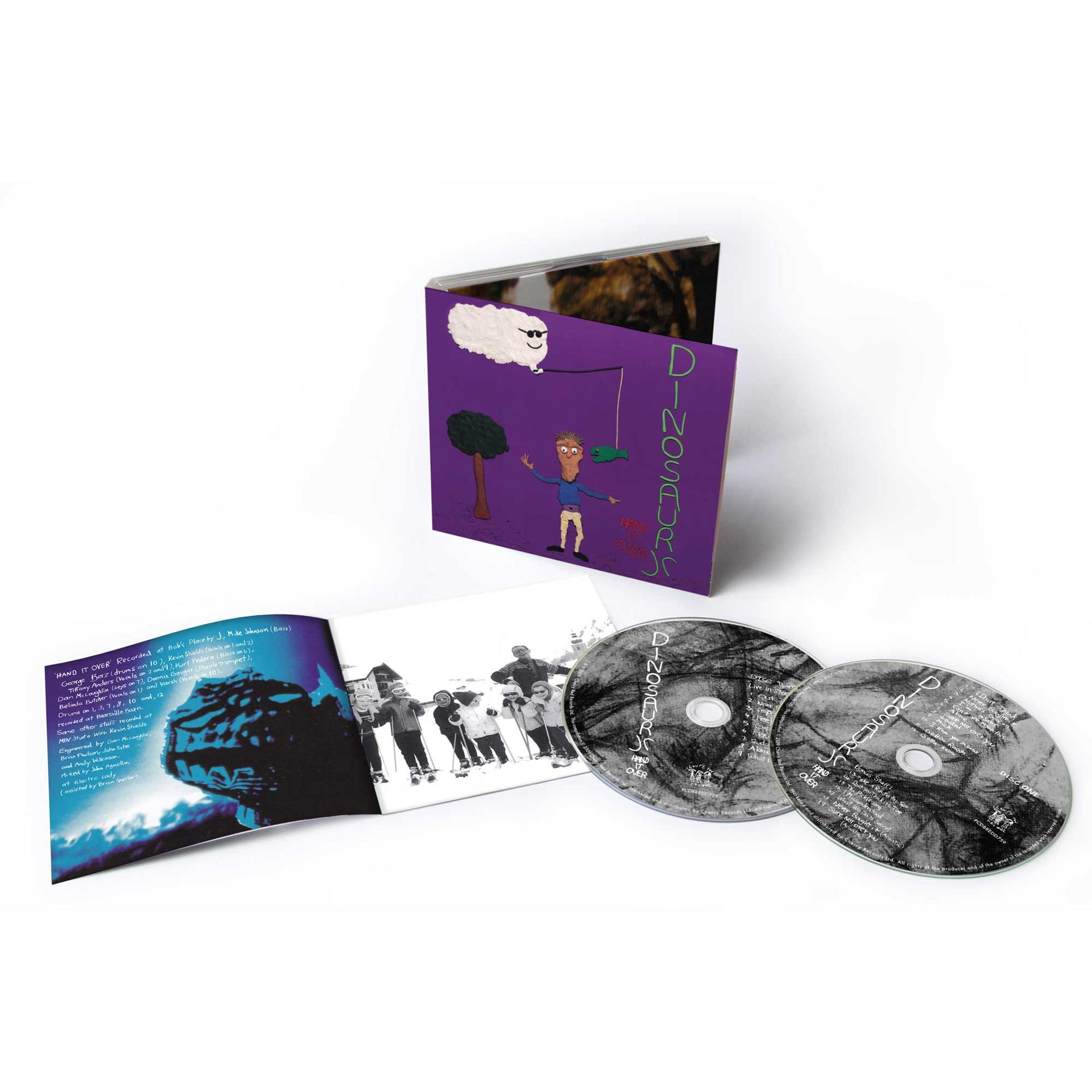 CD-Hülle und -Discs. Lila Albumcover mit Cartoon und Text. CDs sichtbar.