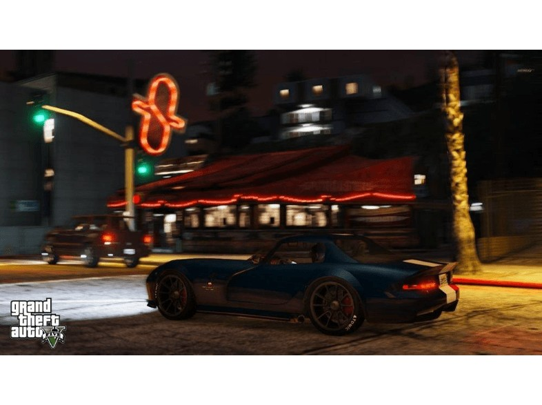 Un coche deportivo azul aparcado de noche frente a un restaurante con un letrero de neón.