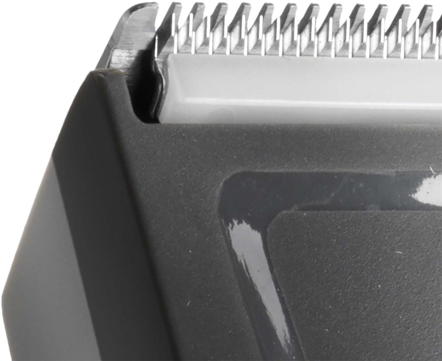 Close-up of a hair clipper blade, showing the sharp teeth and the body.