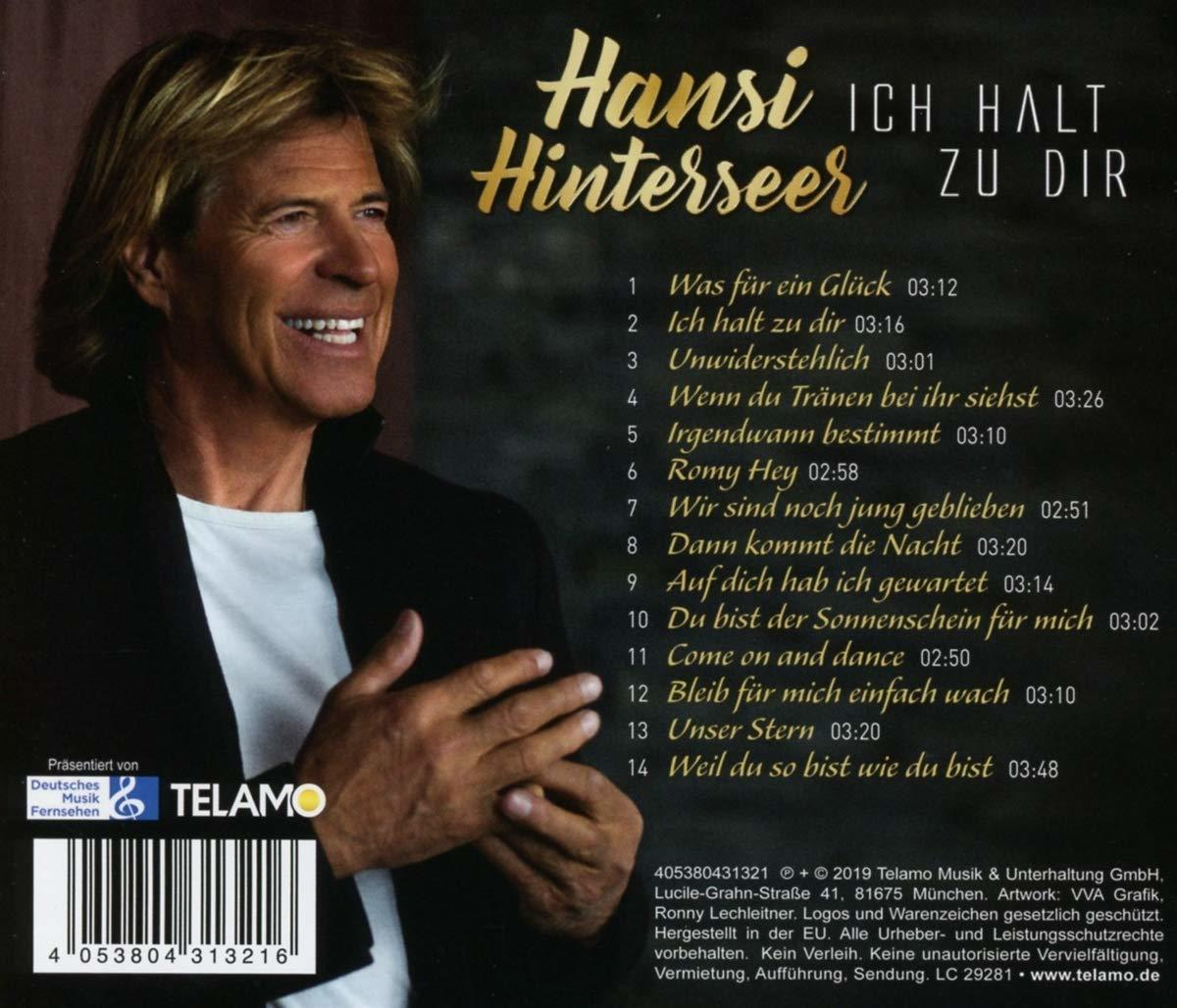 CD-Cover mit einem lächelnden Mann und Songtiteln auf der Rückseite.