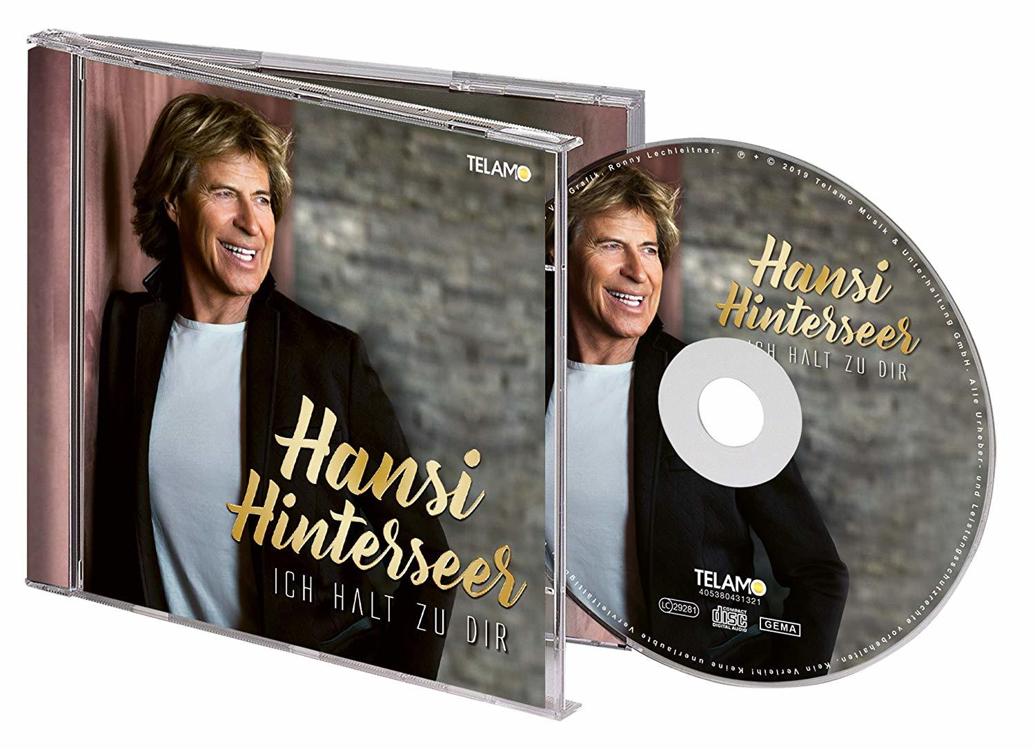 CD-Hülle mit lächelndem Mann, goldfarbenem Text und einer CD mit demselben Mann.