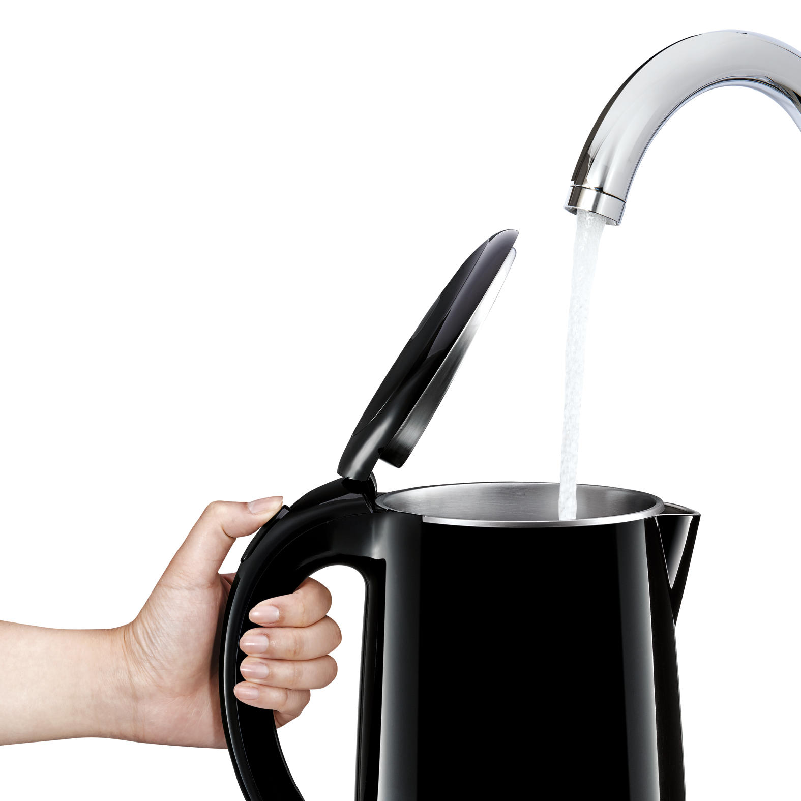A black electric kettle being filled with water from a chrome faucet.