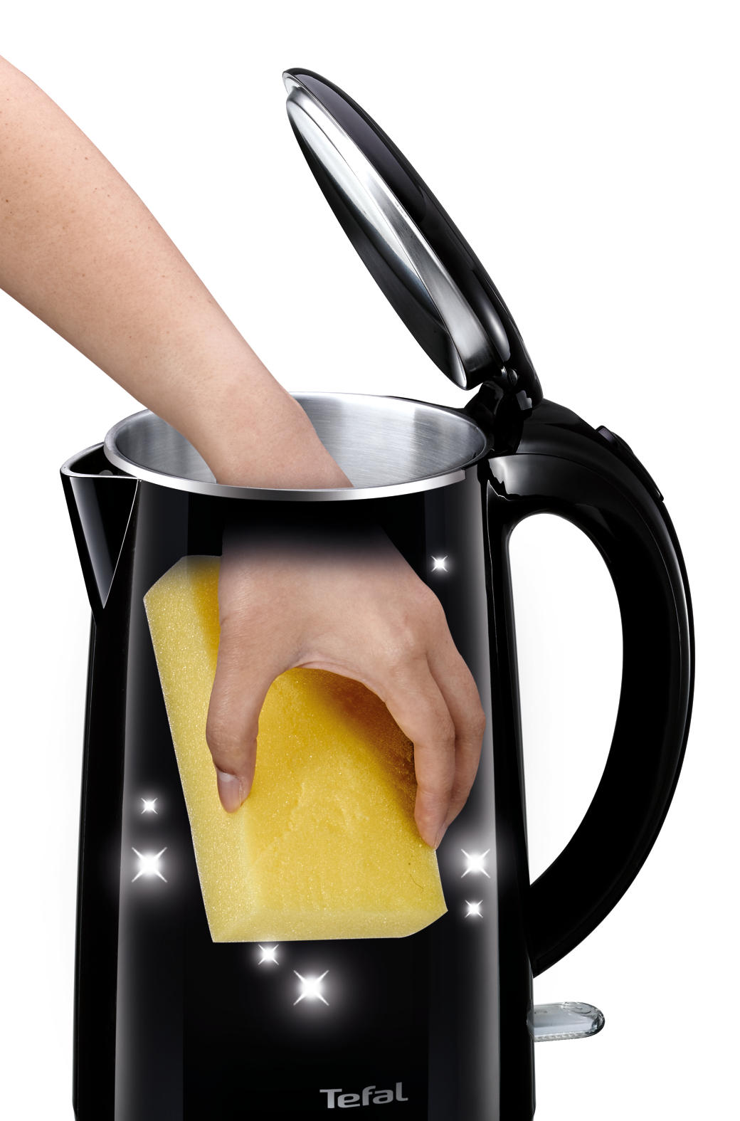 Hand cleaning a black kettle's inside with a yellow sponge, sparkles visible.