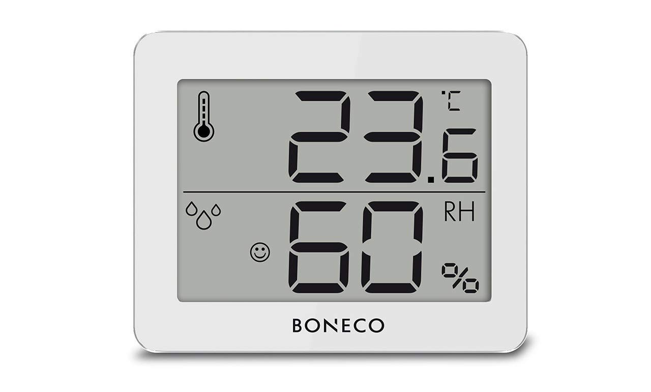 Thermomètre numérique blanc affichant température et humidité. Écran gris.