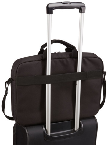 Black laptop bag on a rolling suitcase, secured with a strap.