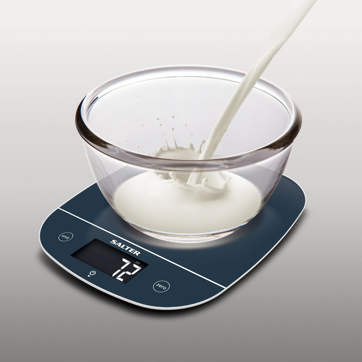 Milk pouring into a clear bowl on a digital kitchen scale, showing 72 ml.