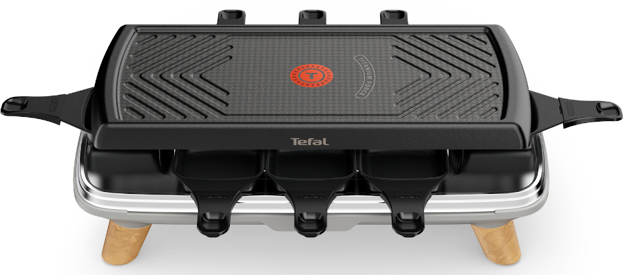 A black raclette grill with three cheese holders, TeFal logo, and a grilling surface.