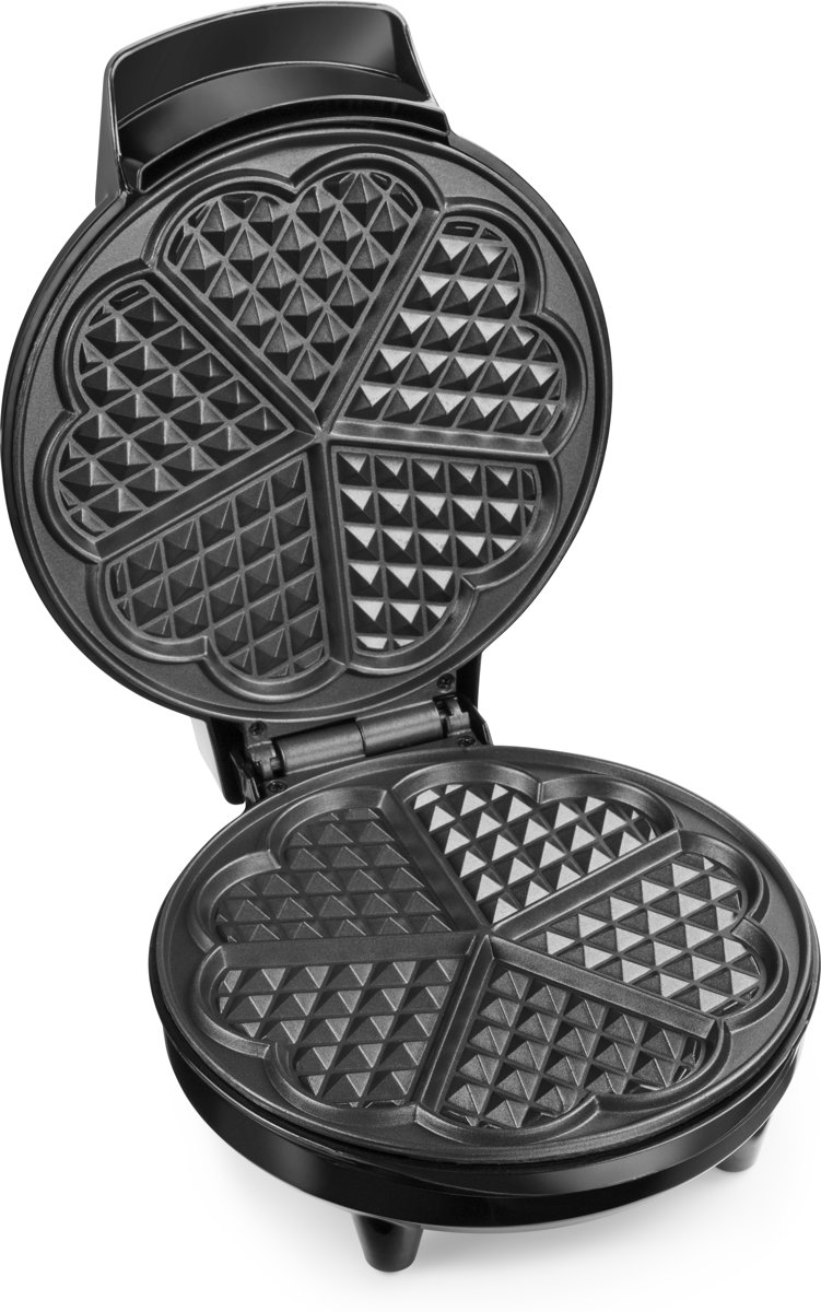Black waffle iron. Open, revealing six heart-shaped waffle molds. Detail of grid pattern.