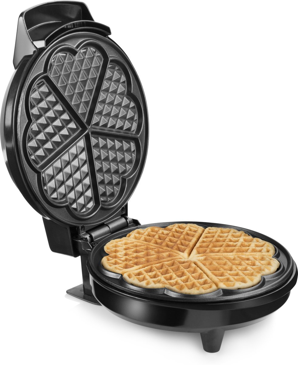 Waffle maker with a waffle cooking inside, showing a heart-shaped design.