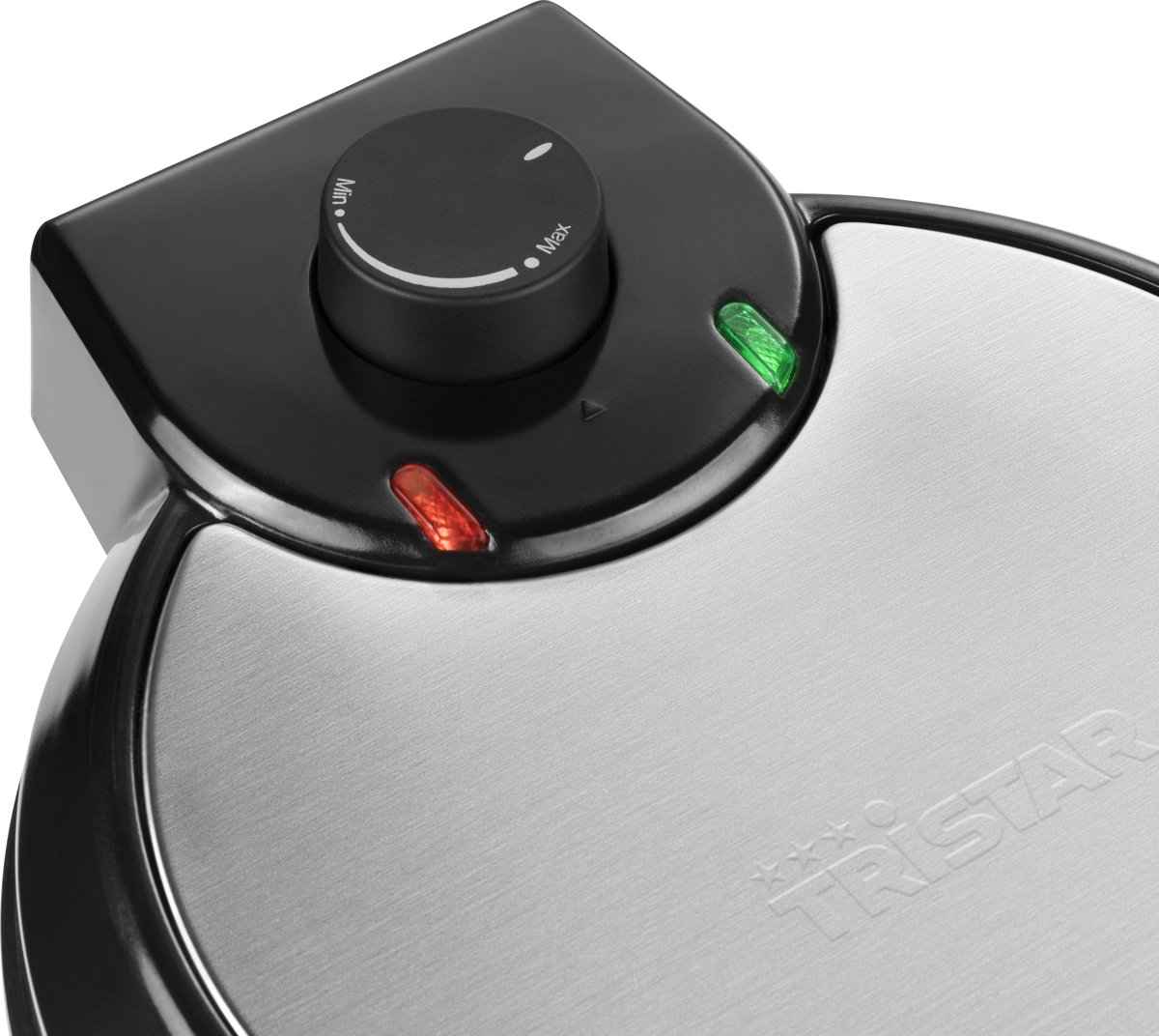 Close-up of a black and silver waffle maker with lights and a knob.